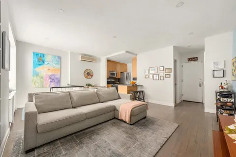 a living room with furniture and painting on the wall