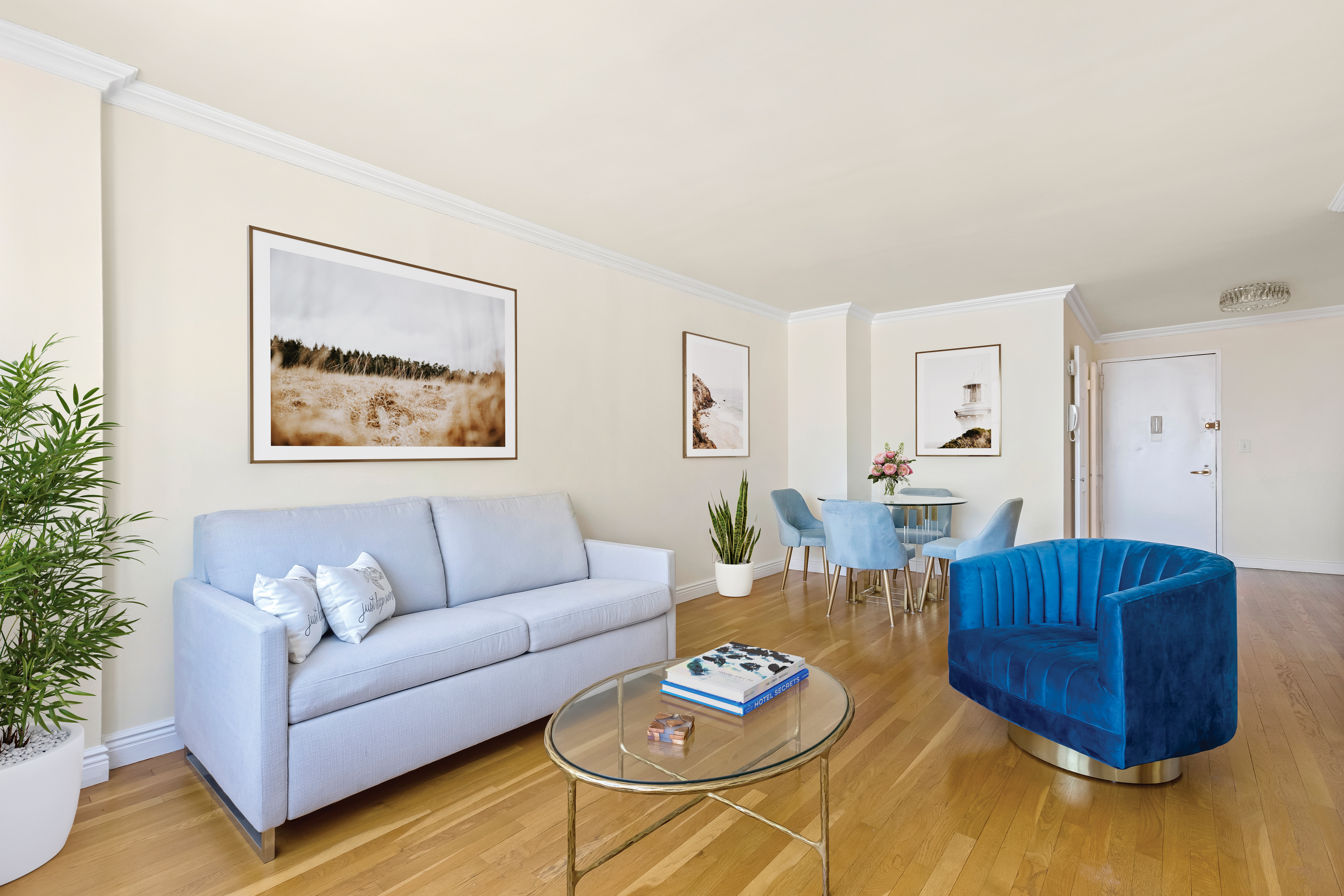 a living room with furniture a rug and a lamp
