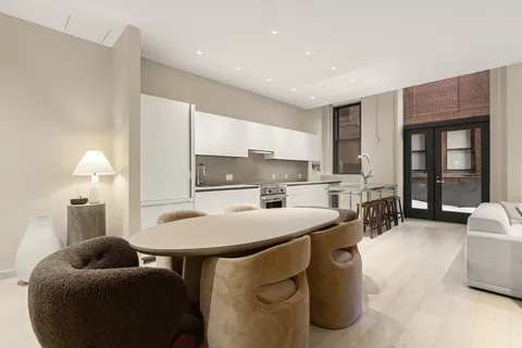 a kitchen with stainless steel appliances kitchen island granite countertop a sink and a refrigerator