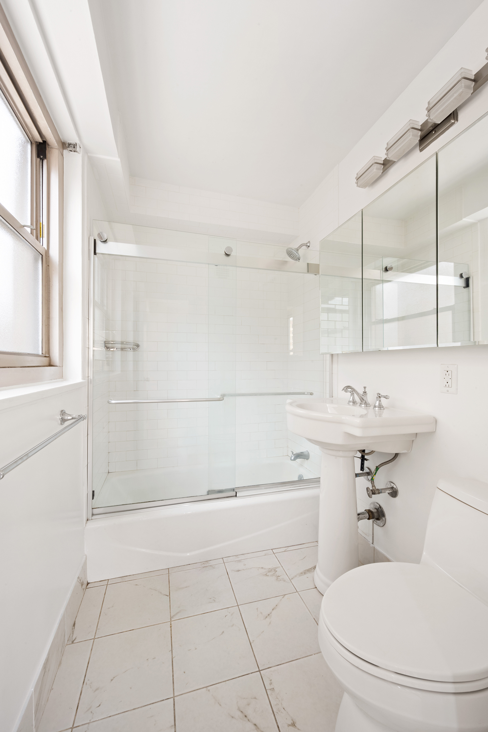 137 East 36th Street, Unit 11D Manhattan, NY 10016 - Photo 5 of 12 a bathroom with a sink a toilet and shower