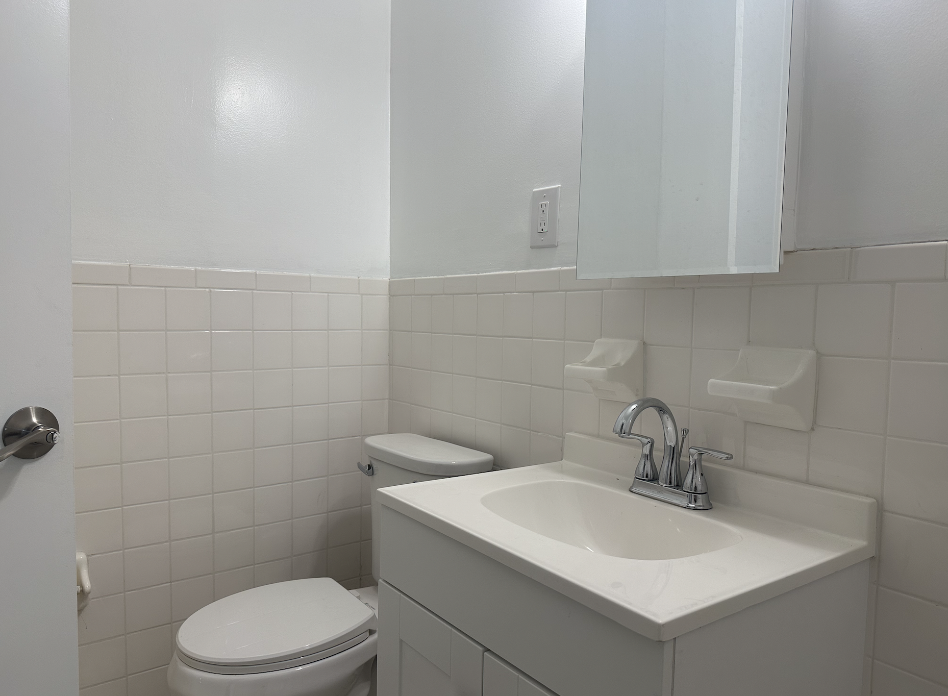 458 West 57th Street, Unit 4FE Manhattan, NY 10019 - Photo 12 of 13 a bathroom with a toilet sink and mirror
