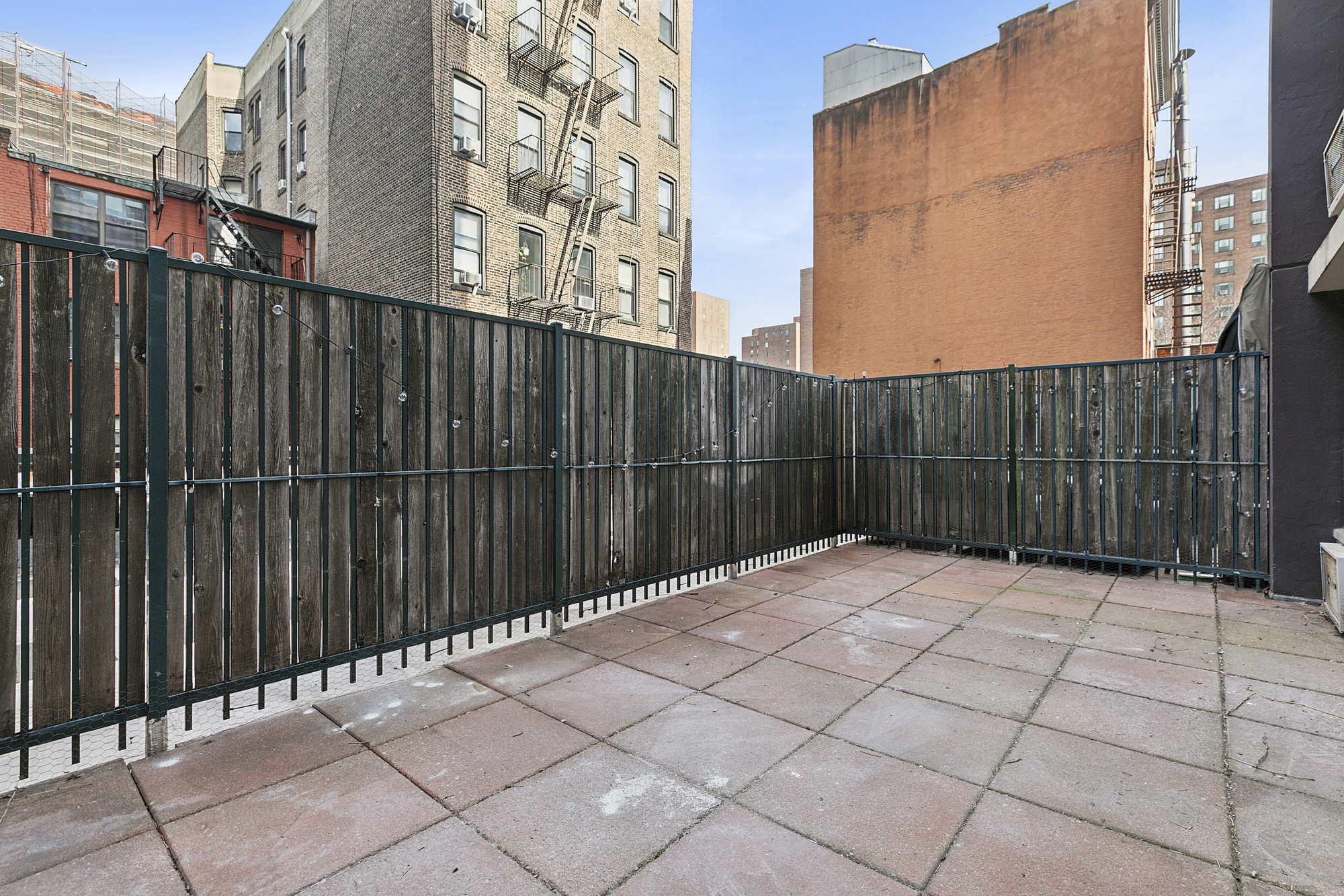333 East 14th Street, Unit 2C Manhattan, NY 10003 - Photo 8 of 12 a view of backyard with wooden fence