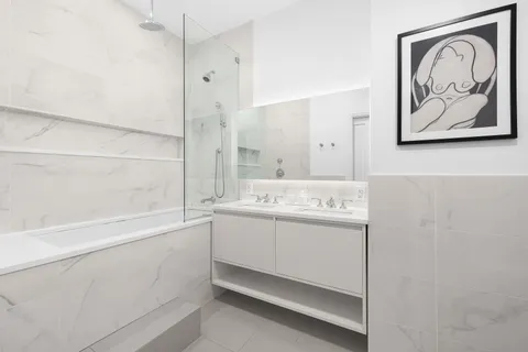 a bathroom with a bathtub and a shower