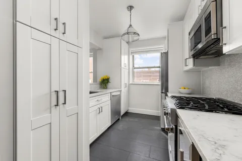 a kitchen with stainless steel appliances a refrigerator sink and cabinets