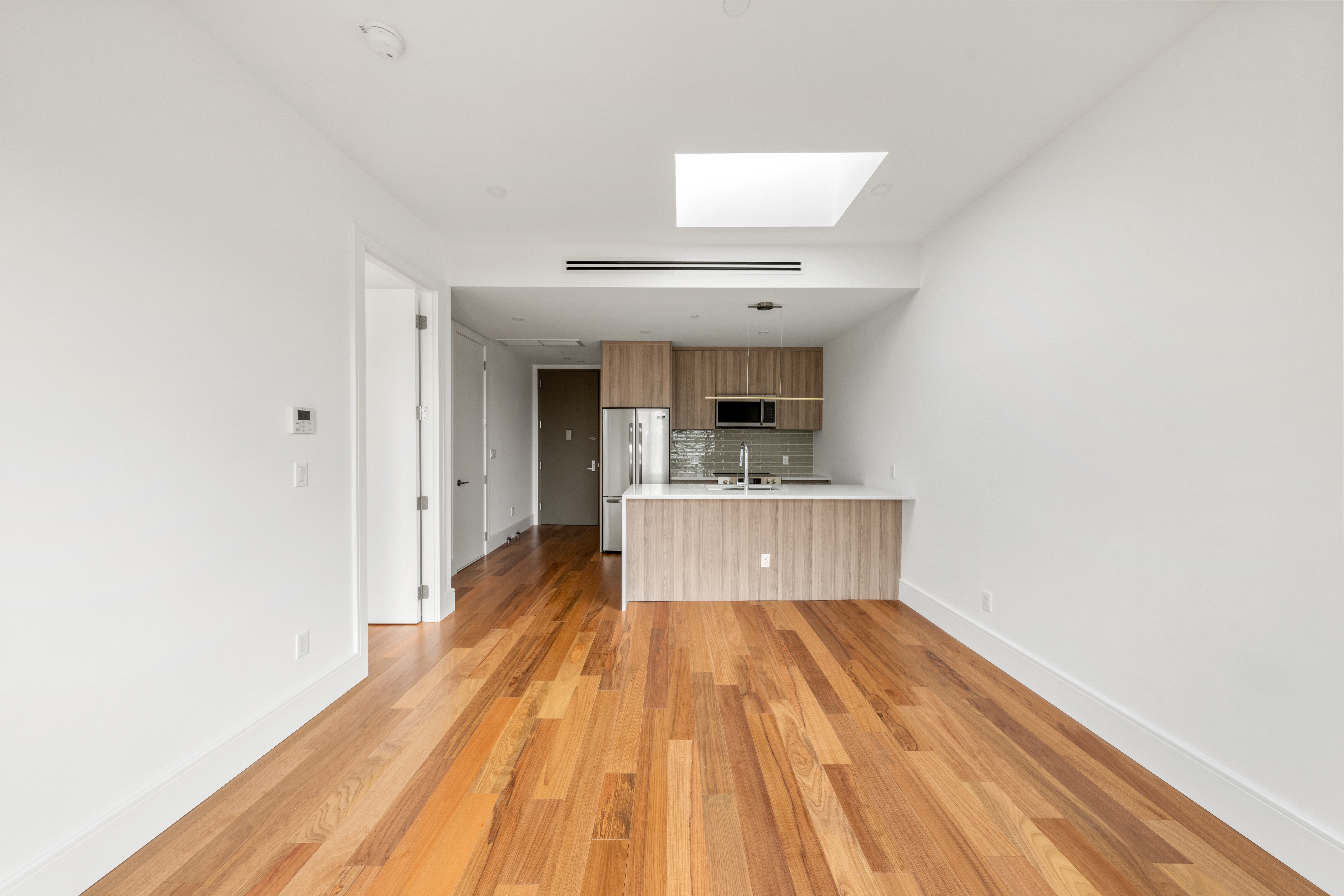 82 Cooper Street, Unit 3A Brooklyn, NY 11207 - Photo 11 of 17 a view of kitchen with sink and wooden floor