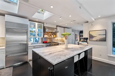 a dining room with furniture and a floor to ceiling window