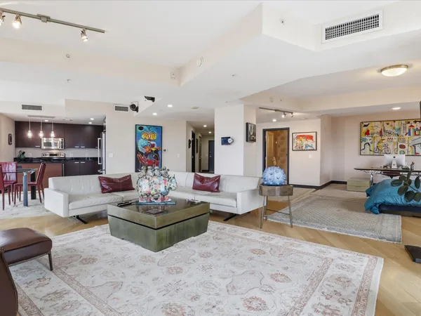 a living room with furniture and wooden floor