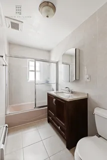 a bathroom with a sink a toilet and mirror