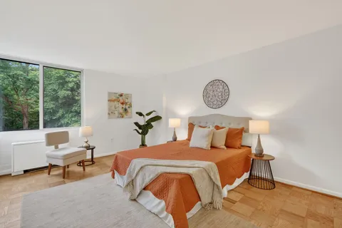 a bed room with a bed and a chair