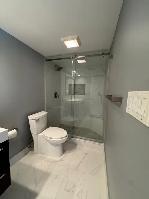 a bathroom with a toilet sink and shower