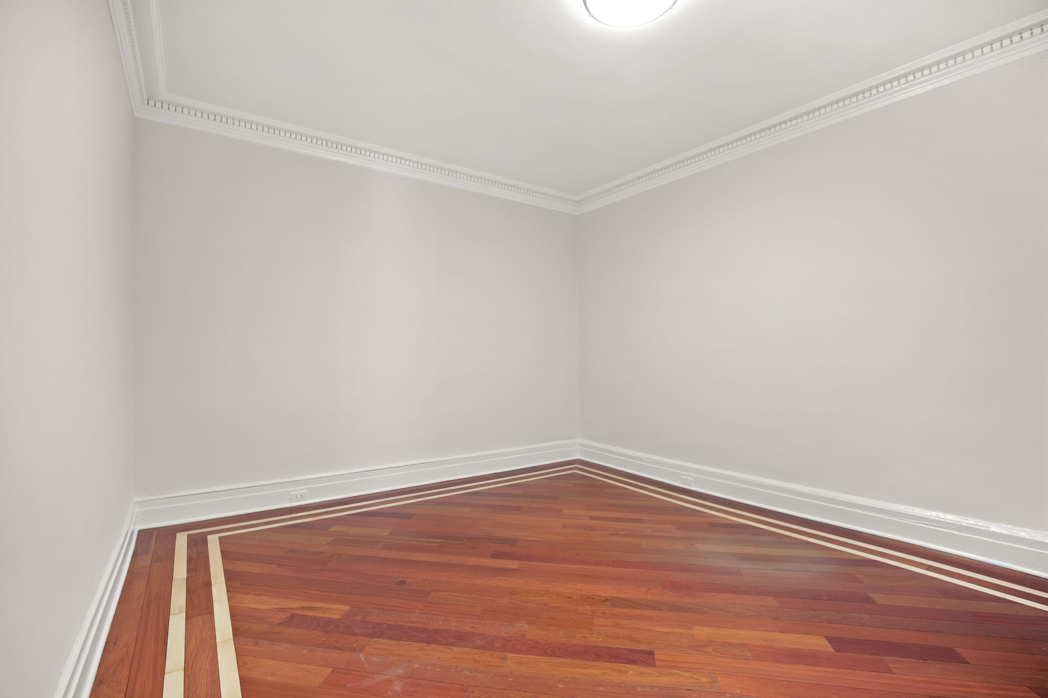 305 West 72nd Street, Unit 7D Manhattan, NY 10023 - Photo 10 of 12 a view of an empty room with wooden floor
