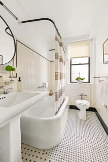 a white bath tub sitting next to a white toilet