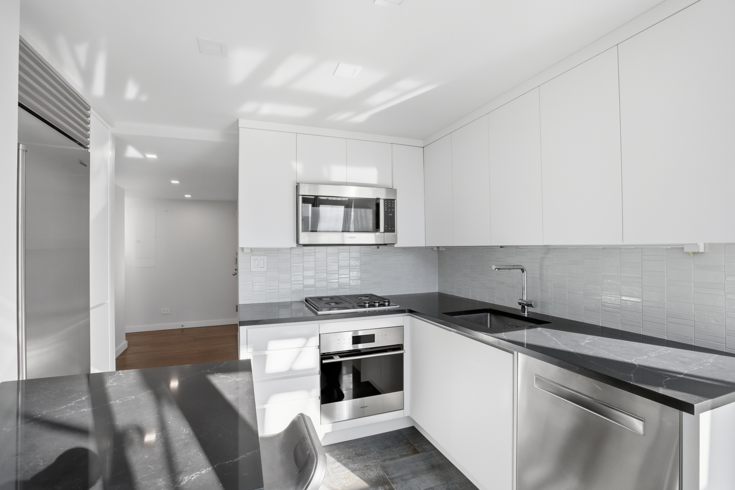 309 East 49th Street, Unit 21A Manhattan, NY 10017 - Photo 10 of 18 a kitchen with a stove and a refrigerator