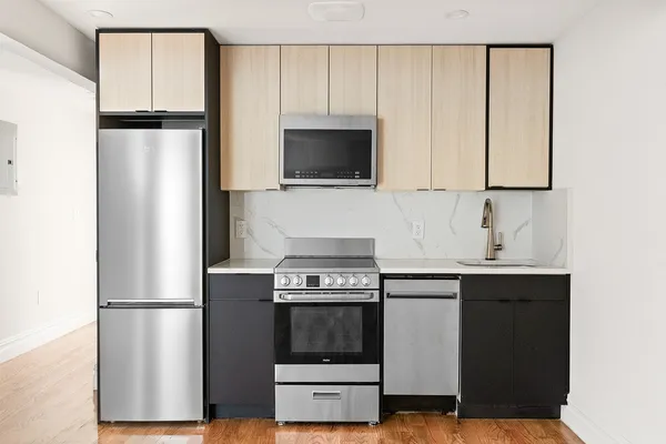 a kitchen with a refrigerator and a stove
