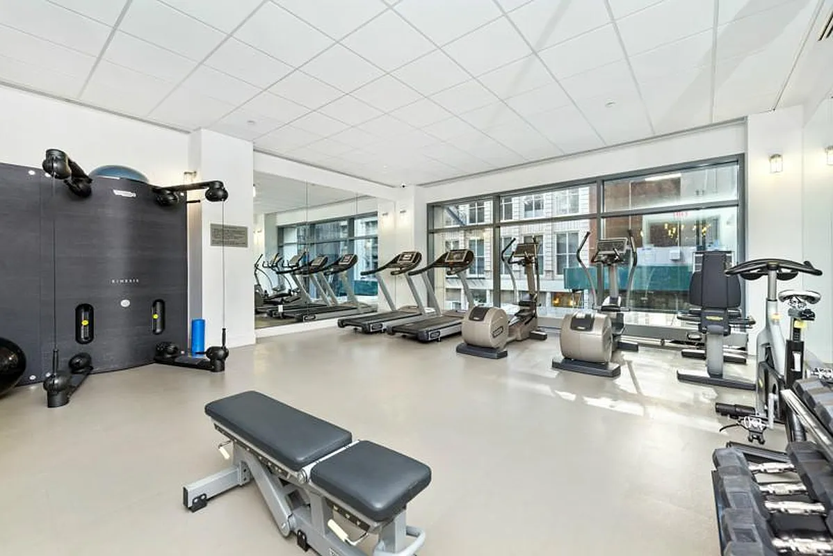 57 Reade Street, Unit 14C Manhattan, NY 10007 - Photo 14 of 16 a room with gym equipment and a large window