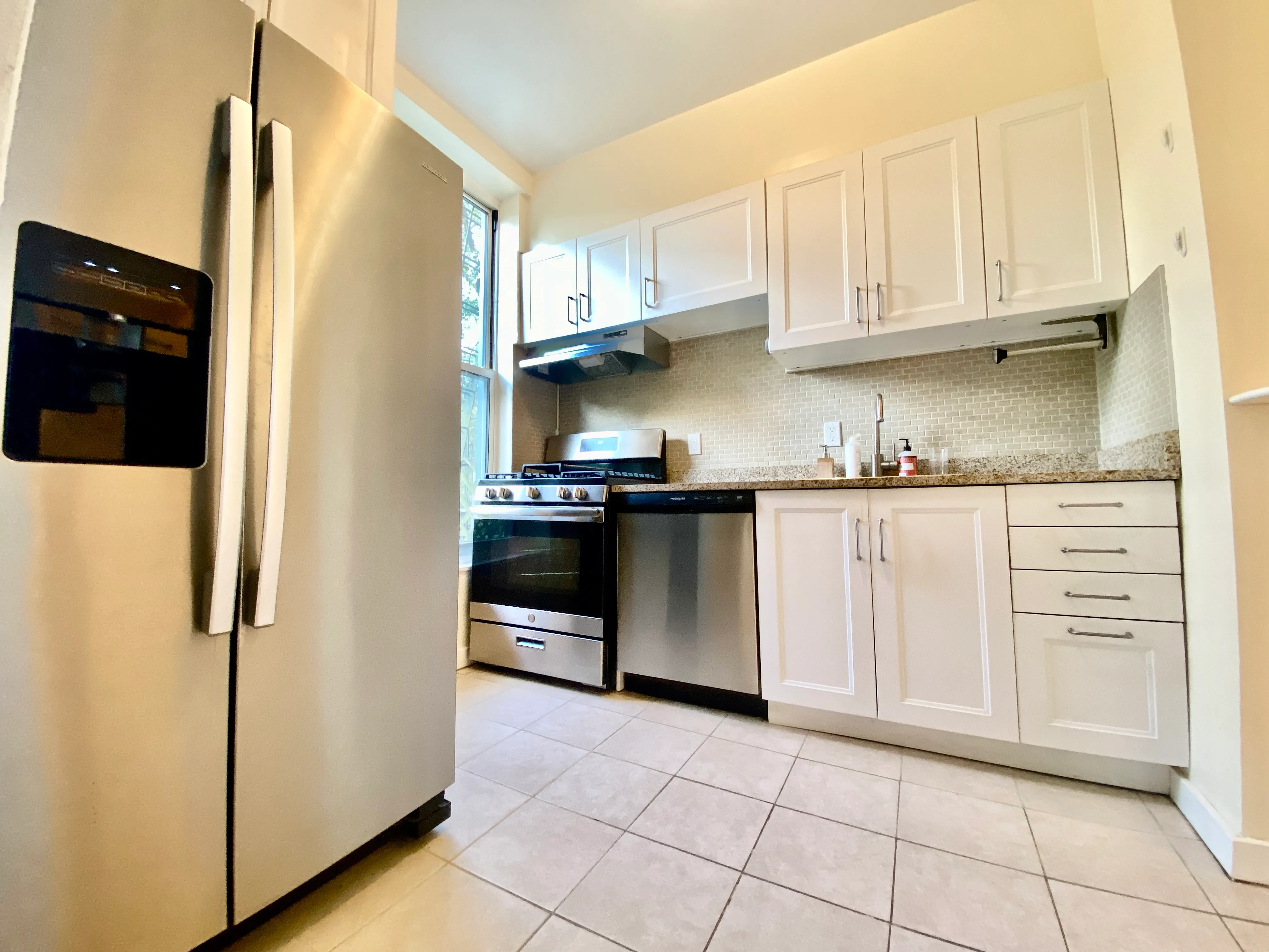 87 Wyckoff Street, Unit 3 Brooklyn, NY 11201 - Photo 4 of 10 a kitchen with white cabinets and refrigerator