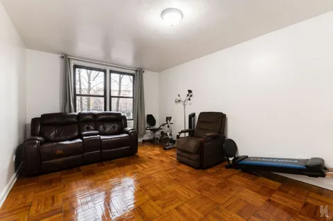 a living room with furniture window and a air conditioner vent
