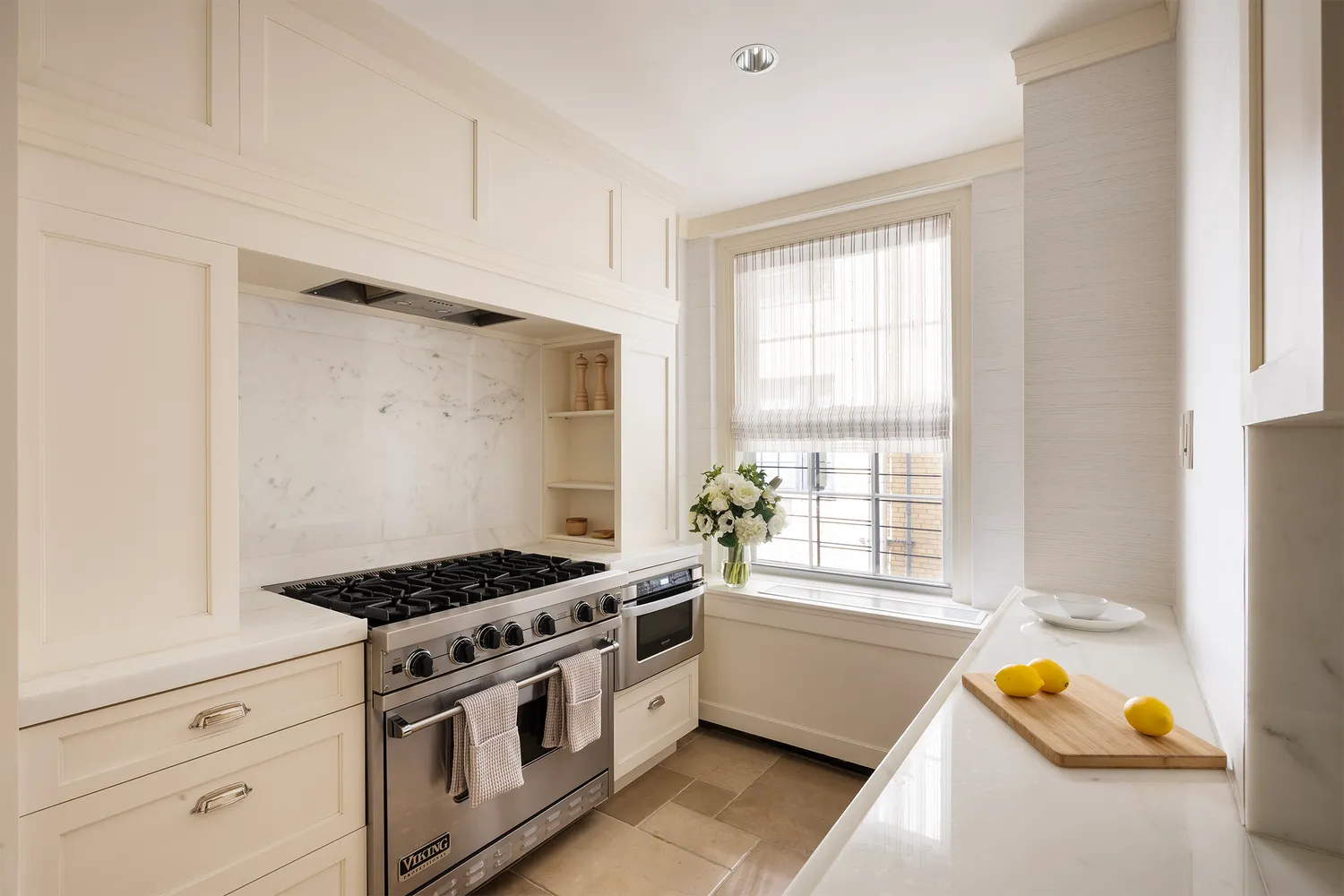 a kitchen with stainless steel appliances granite countertop a sink stove and white cabinets