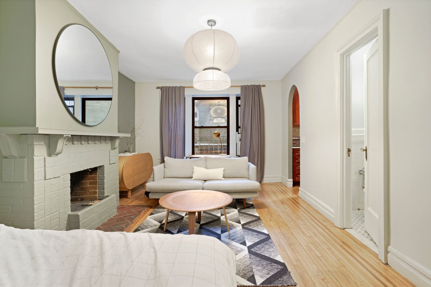 a living room with furniture a fireplace and a chandelier