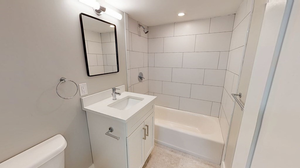 89 Woodrow Avenue, Unit 6 Boston, MA 02124 - Photo 6 of 8 a bathroom with a sink a toilet and shower