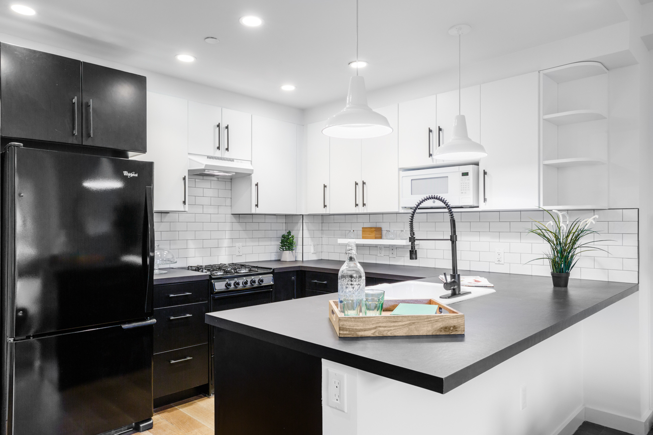 16-26 Madison Street, Unit 4I Queens, NY 11385 - Photo 4 of 18 a kitchen with kitchen island a sink appliances and cabinets