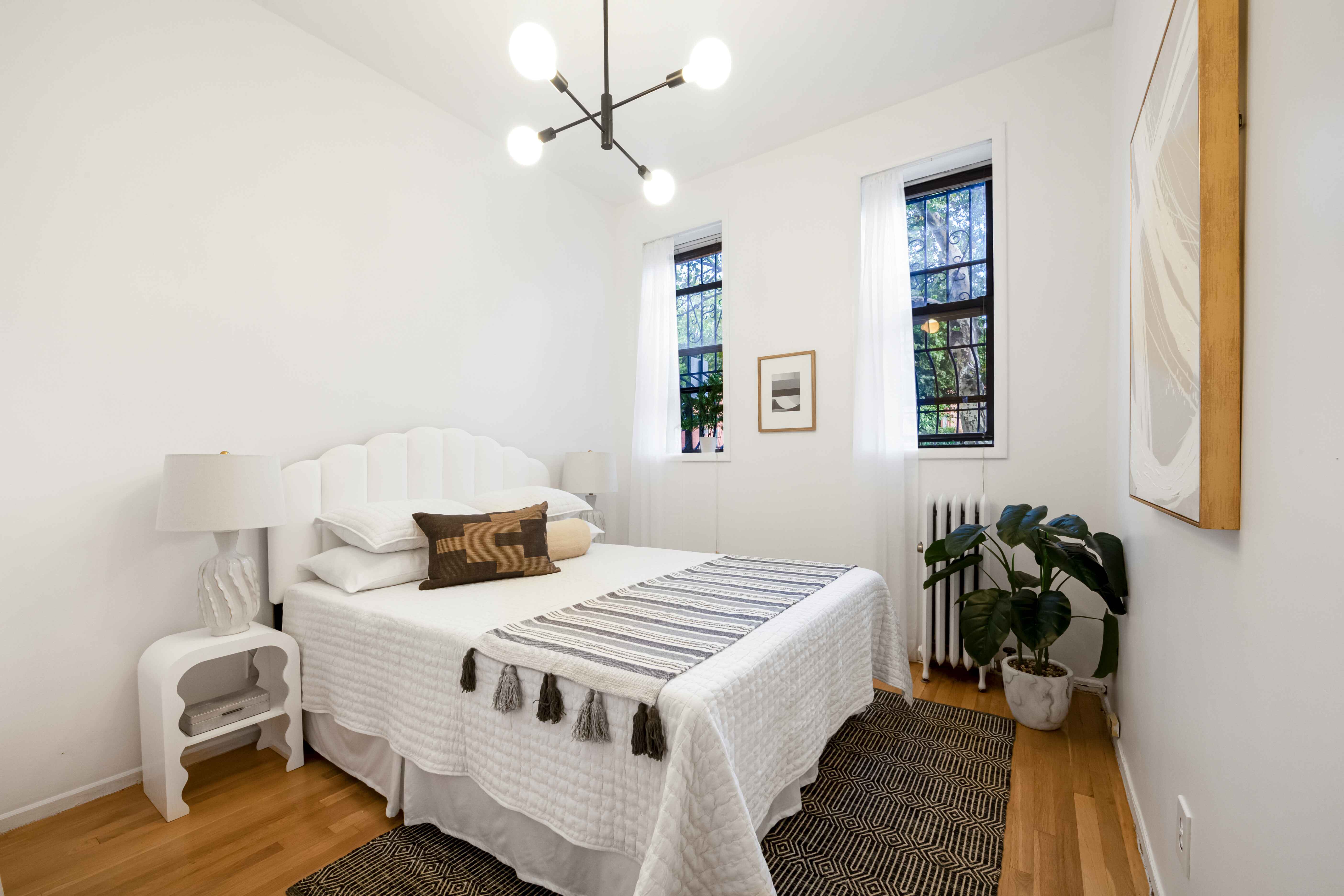 420 6th Avenue, Unit 11 Brooklyn, NY 11215 - Photo 6 of 10 a bedroom with a bed and wooden floor