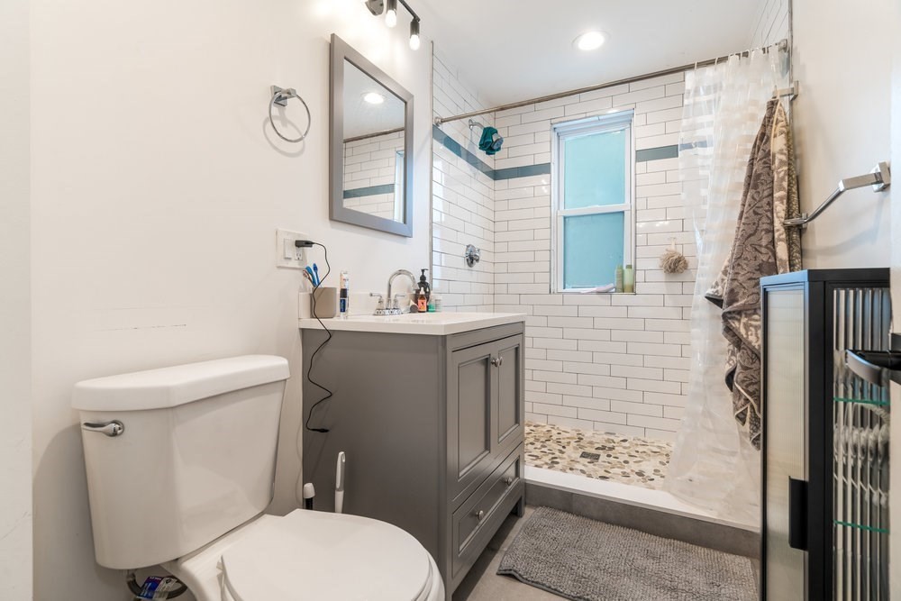 24 Buttonwood Street Boston, MA 02125 - Photo 18 of 43 a bathroom with a toilet sink and shower