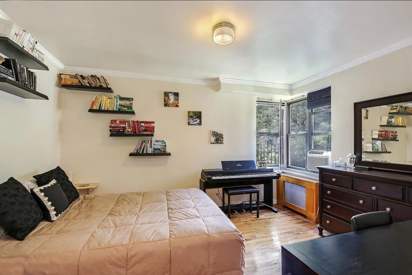 4523 Broadway, Unit 5D Manhattan, NY 10040 - Photo 3 of 10 a bedroom with a bed and wooden floor