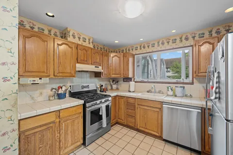 a kitchen with a sink stove and cabinets