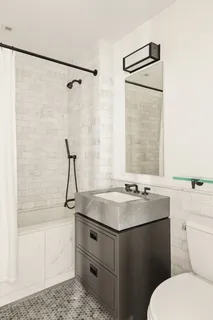 a bathroom with a sink toilet and shower