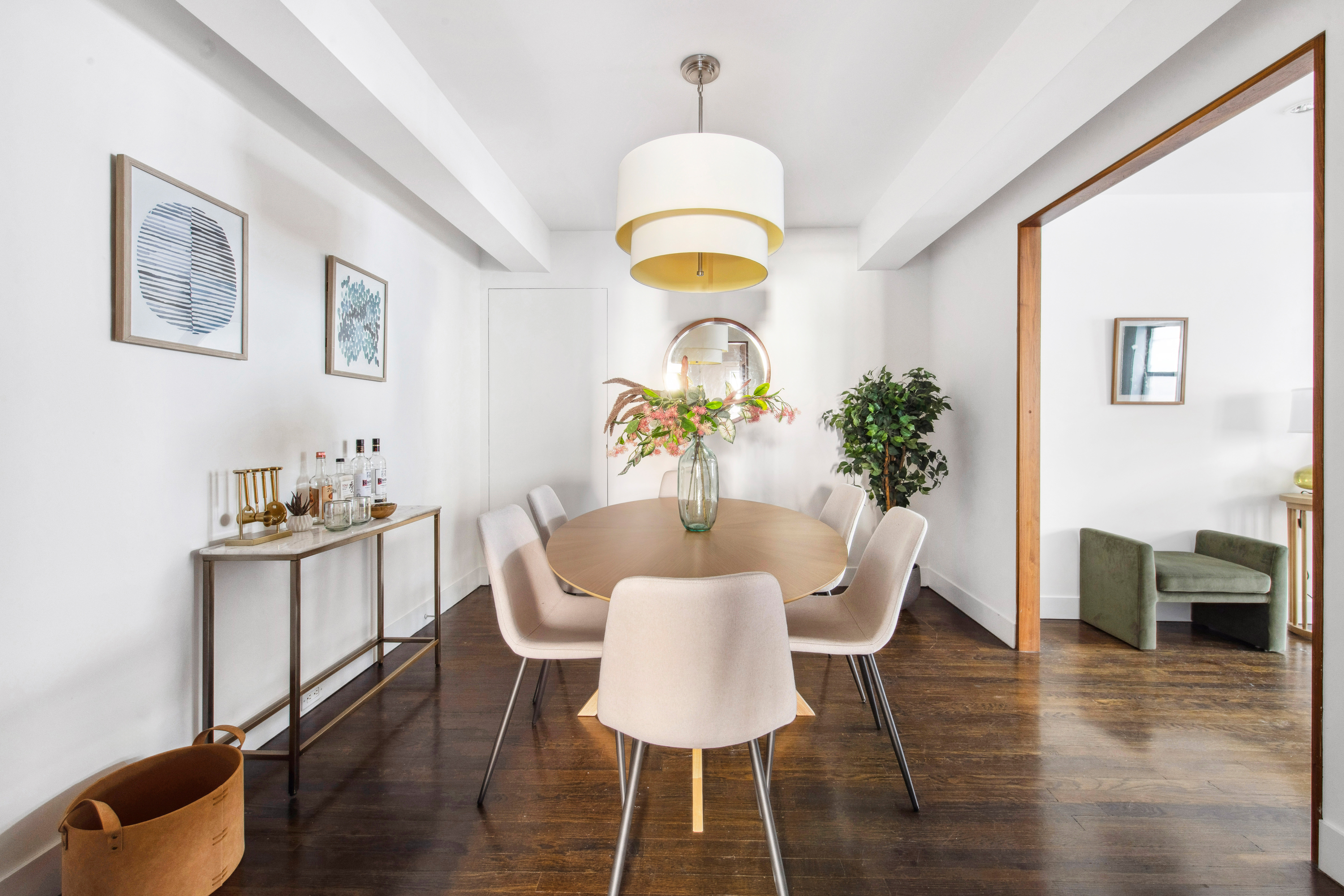 330 East 70th Street, Unit 5AB Manhattan, NY 10021 - Photo 6 of 13 a dining room with furniture potted plants and wooden floor