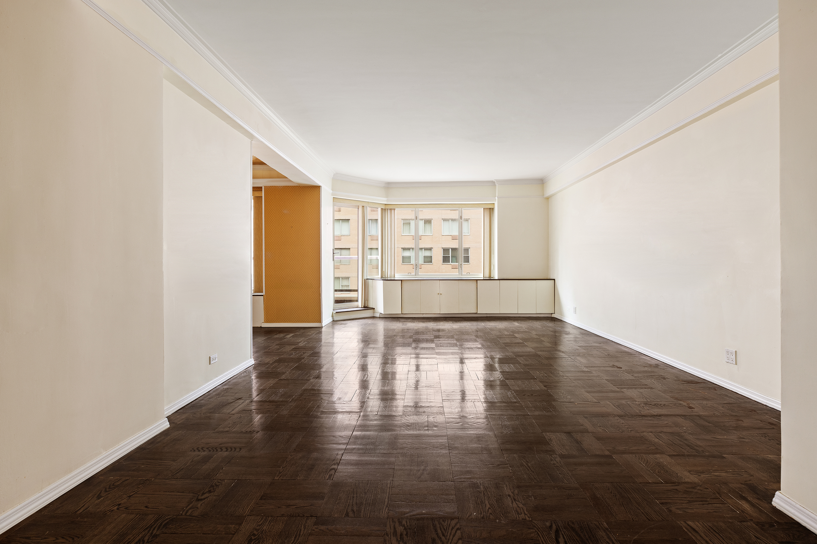 36 Sutton Place South, Unit 10B Manhattan, NY 10022 - Photo 2 of 16 an empty room with wooden floor and windows