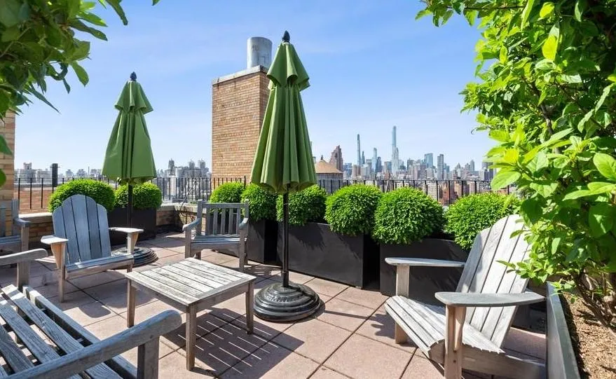 a view of a backyard with furniture and a garden