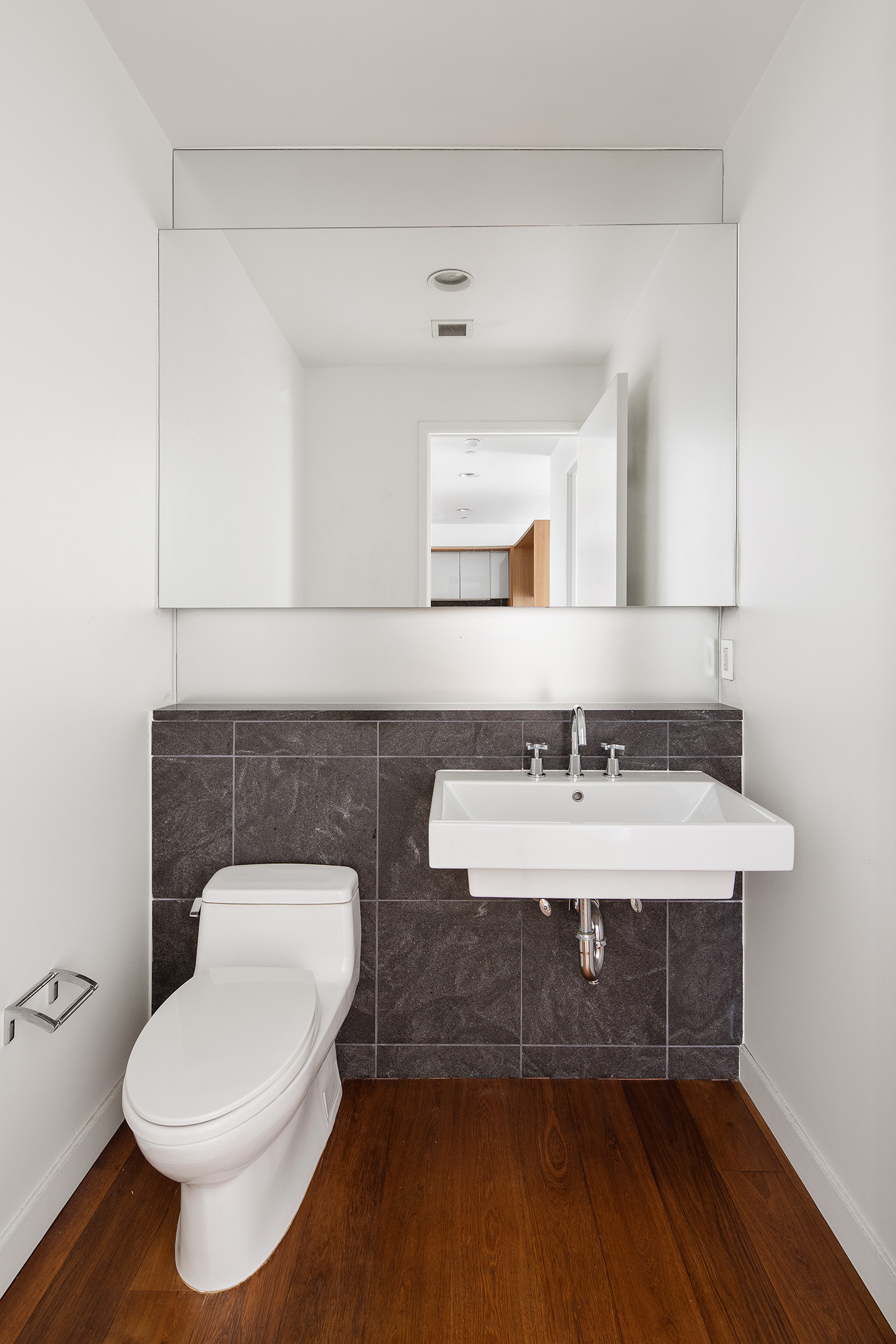 311 West Broadway, Unit 6J Manhattan, NY 10013 - Photo 14 of 19 a bathroom with a toilet a sink and mirror