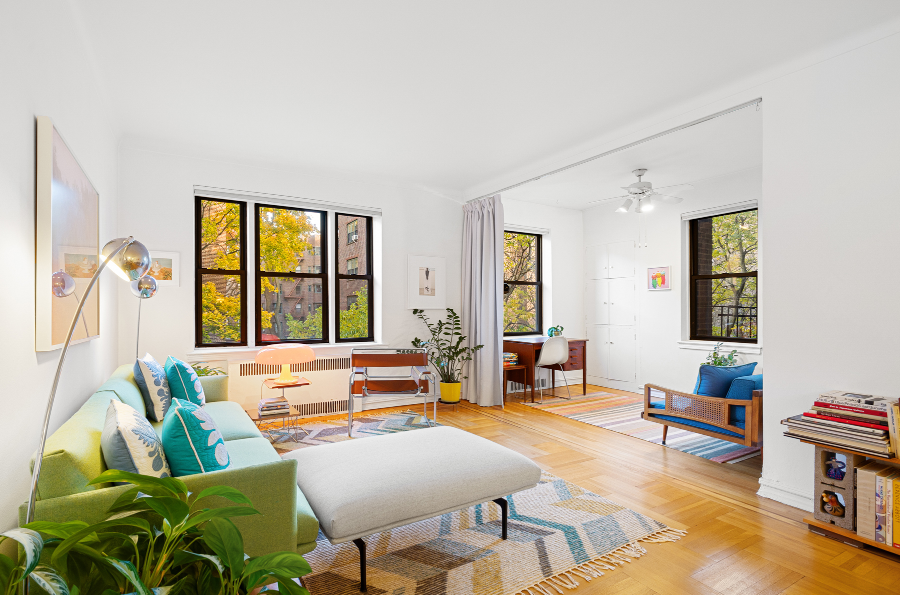 77-11 35th Avenue, Unit 3N Queens, NY 11372 - Photo 4 of 21 a living room with furniture and a large window