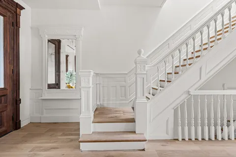 a view of staircase with white walls and windows