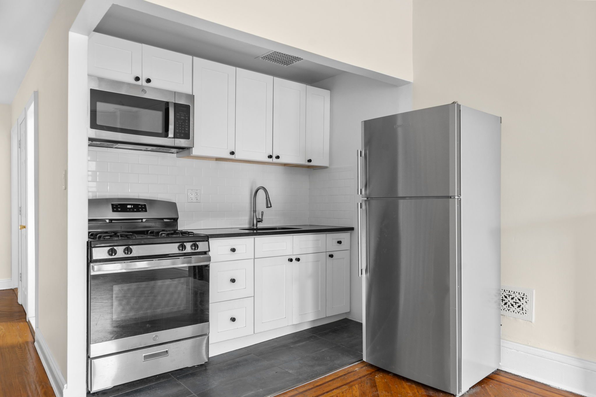 149 Sterling Place, Unit 4 Brooklyn, NY 11217 - Photo 7 of 9 a kitchen with cabinets stainless steel appliances and a counter space
