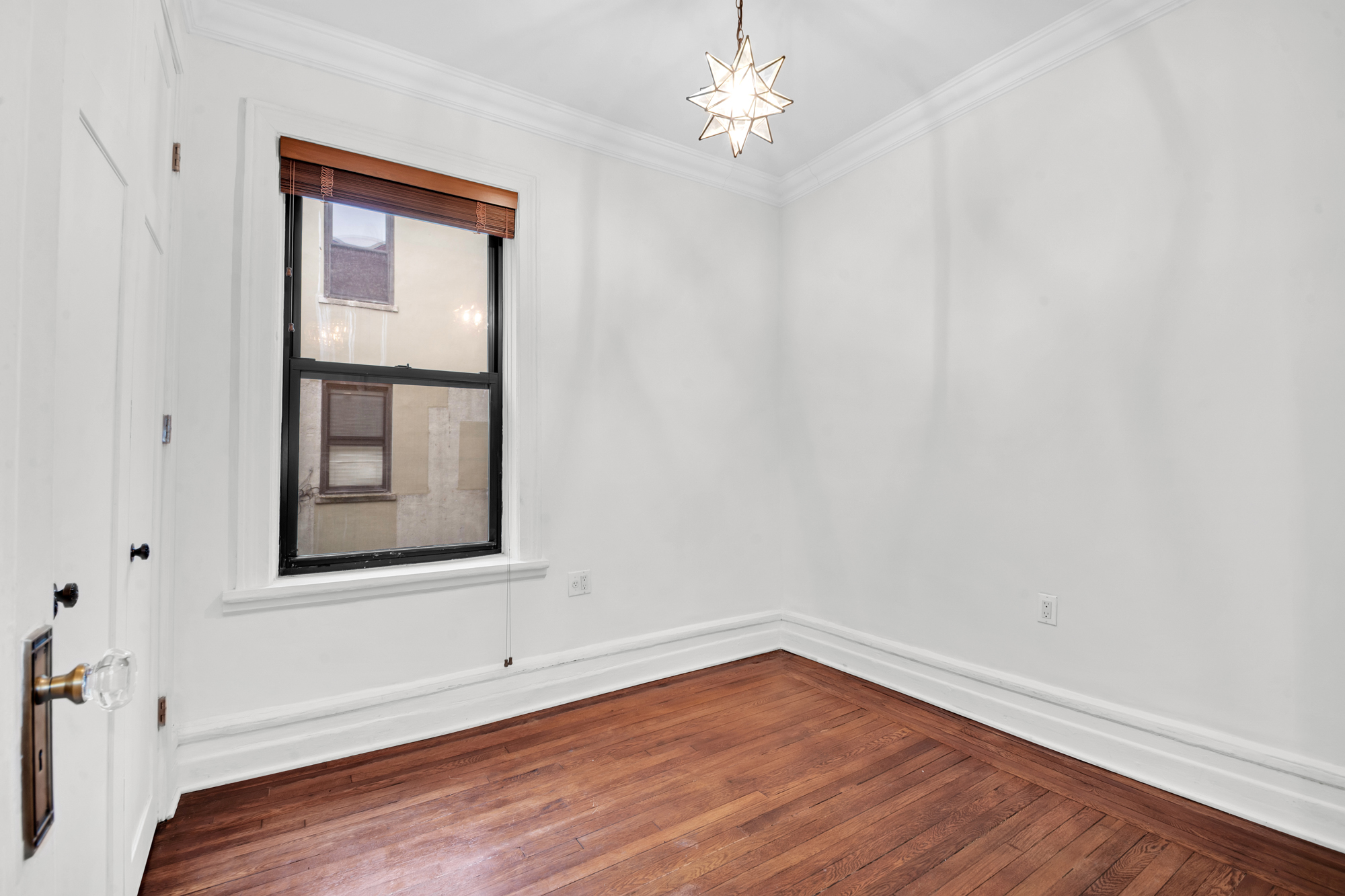 47 Fort Washington Avenue, Unit 55 Manhattan, NY 10032 - Photo 15 of 20 a view of an empty room with wooden floor and a window