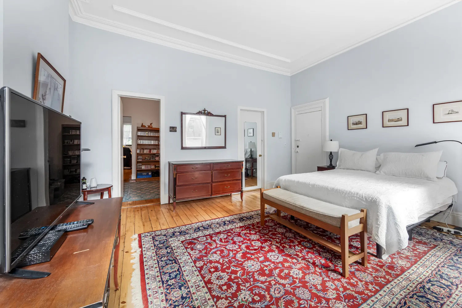 a bedroom with a bed and a television