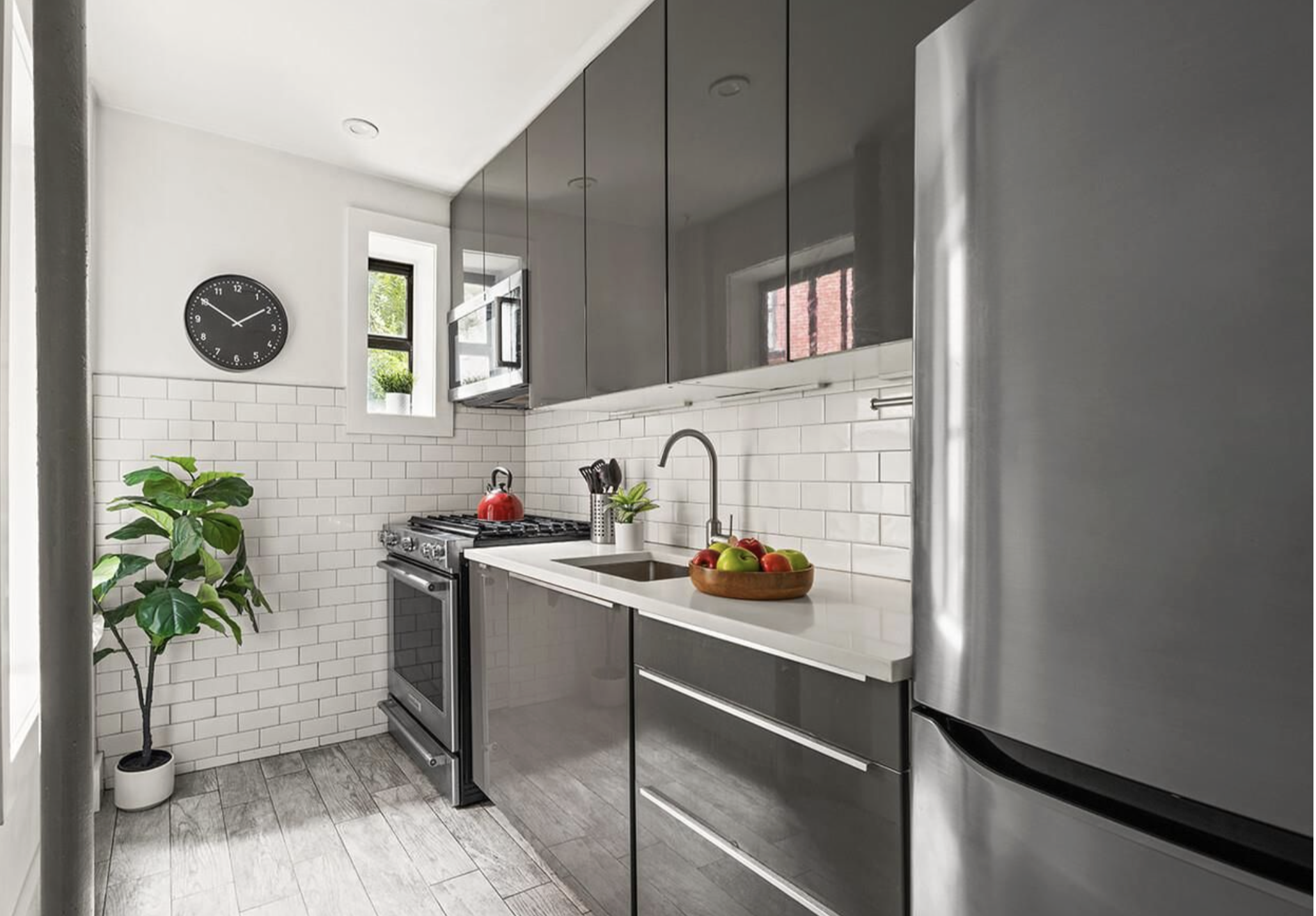 443 Hicks Street, Unit 2E Brooklyn, NY 11201 - Photo 4 of 12 a kitchen with a sink and a stove with wooden floor