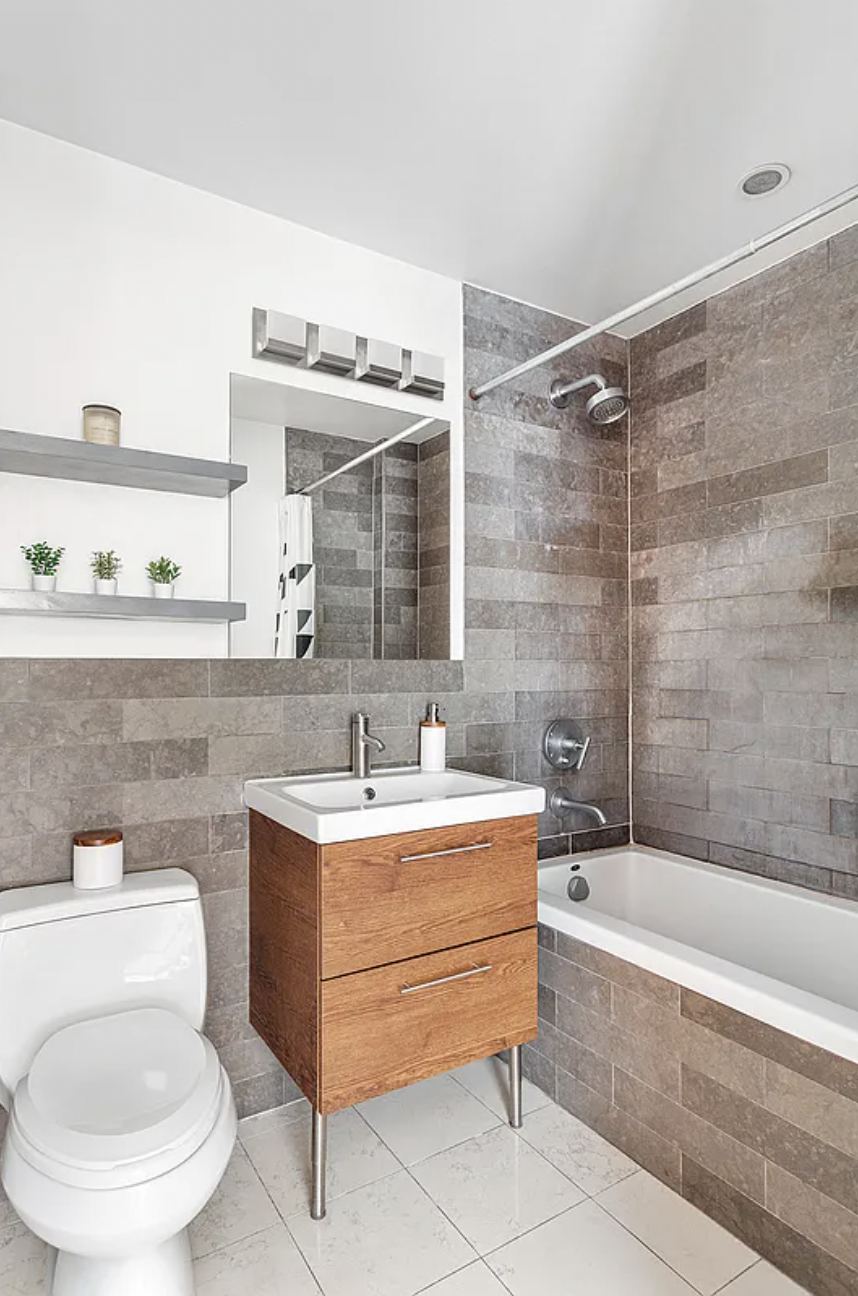 10-63 Jackson Avenue, Unit 7A Queens, NY 11101 - Photo 4 of 11 a bathroom with a sink a toilet and bathtub