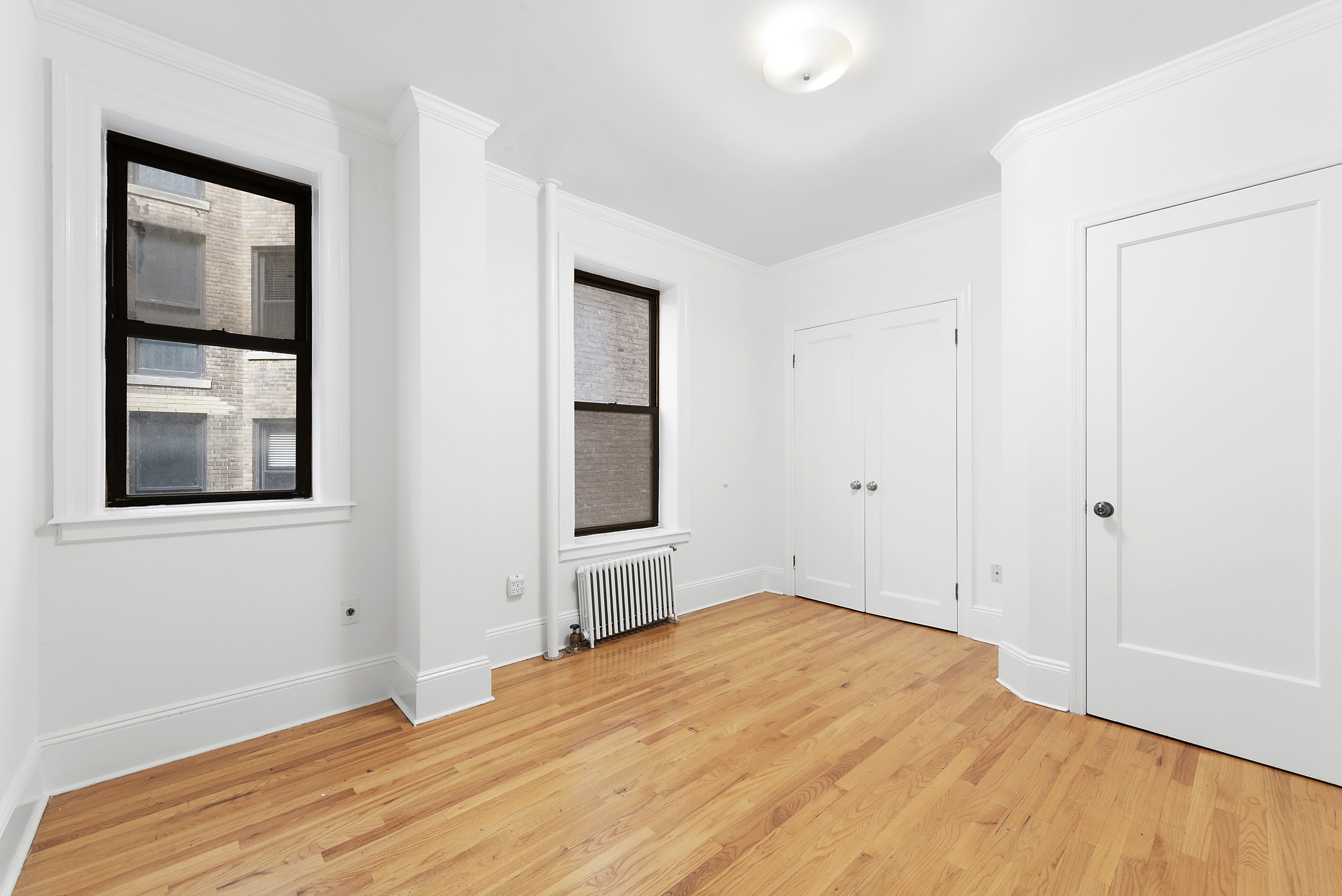 1240 Park Avenue, Unit 4C Manhattan, NY 10128 - Photo 5 of 9 a bedroom with a bed and a window