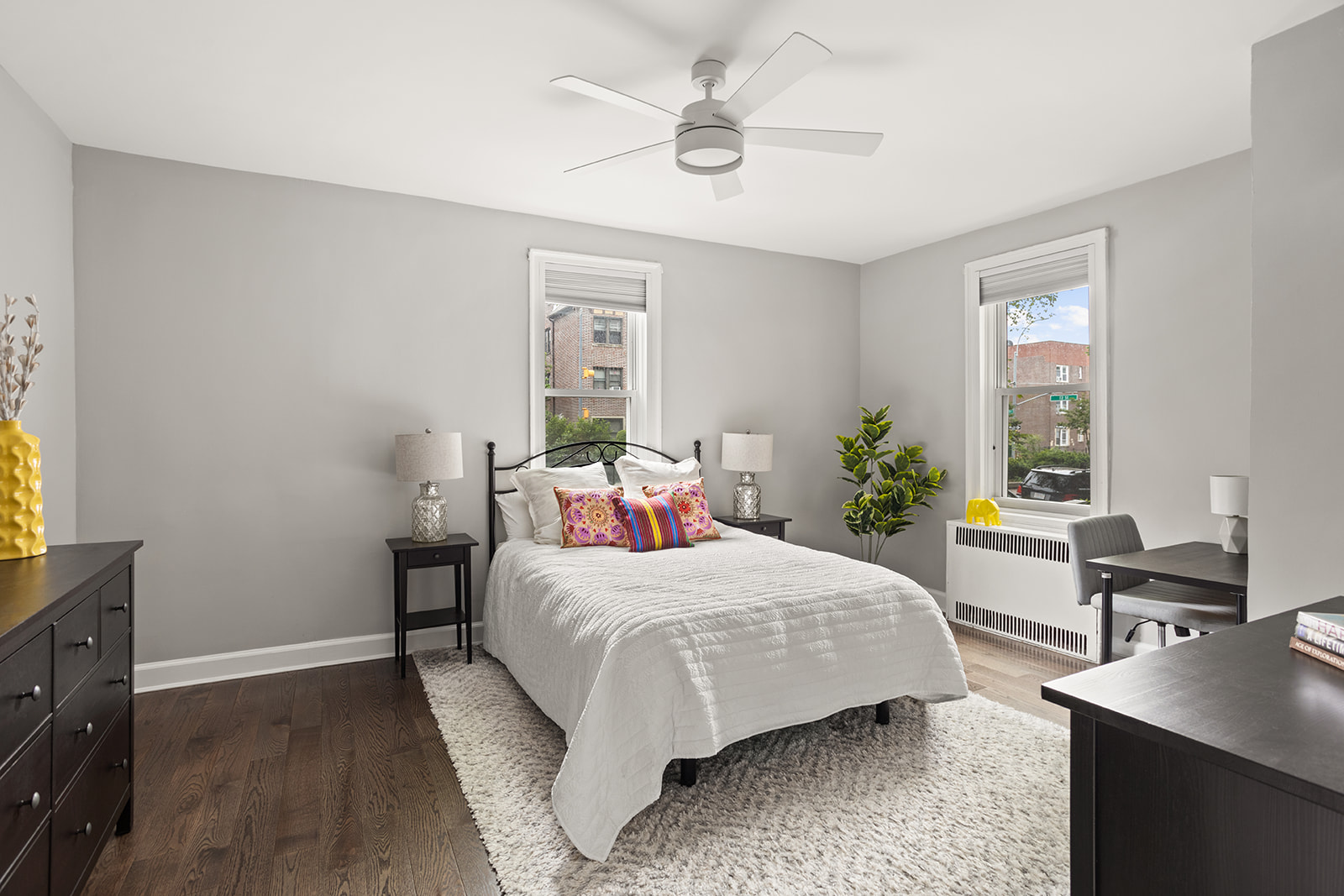 72-17 34th Avenue, Unit 1P Queens, NY 11372 - Photo 7 of 14 a bedroom with a bed and a table in it