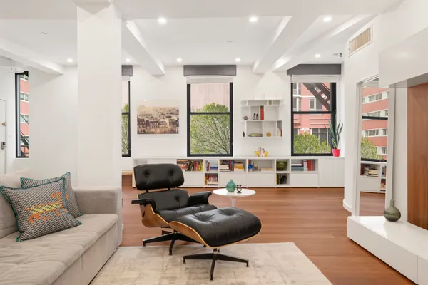 a living room with furniture and large windows