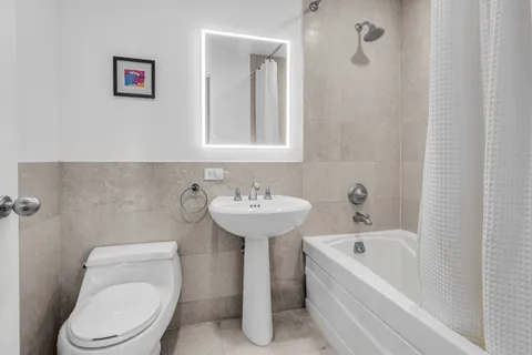 a bathroom with a sink toilet and bathtub