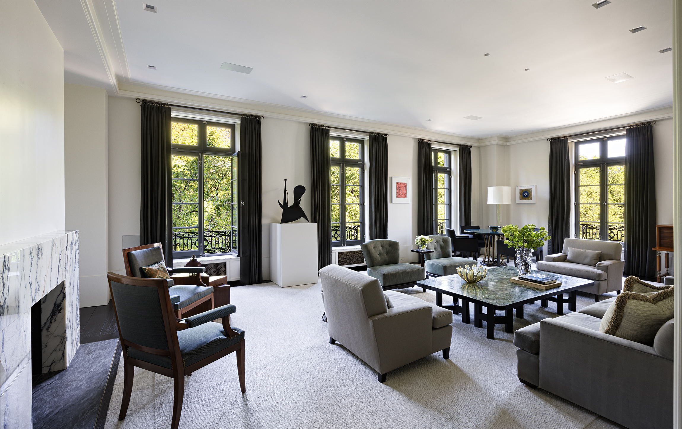 a living room with furniture and large windows
