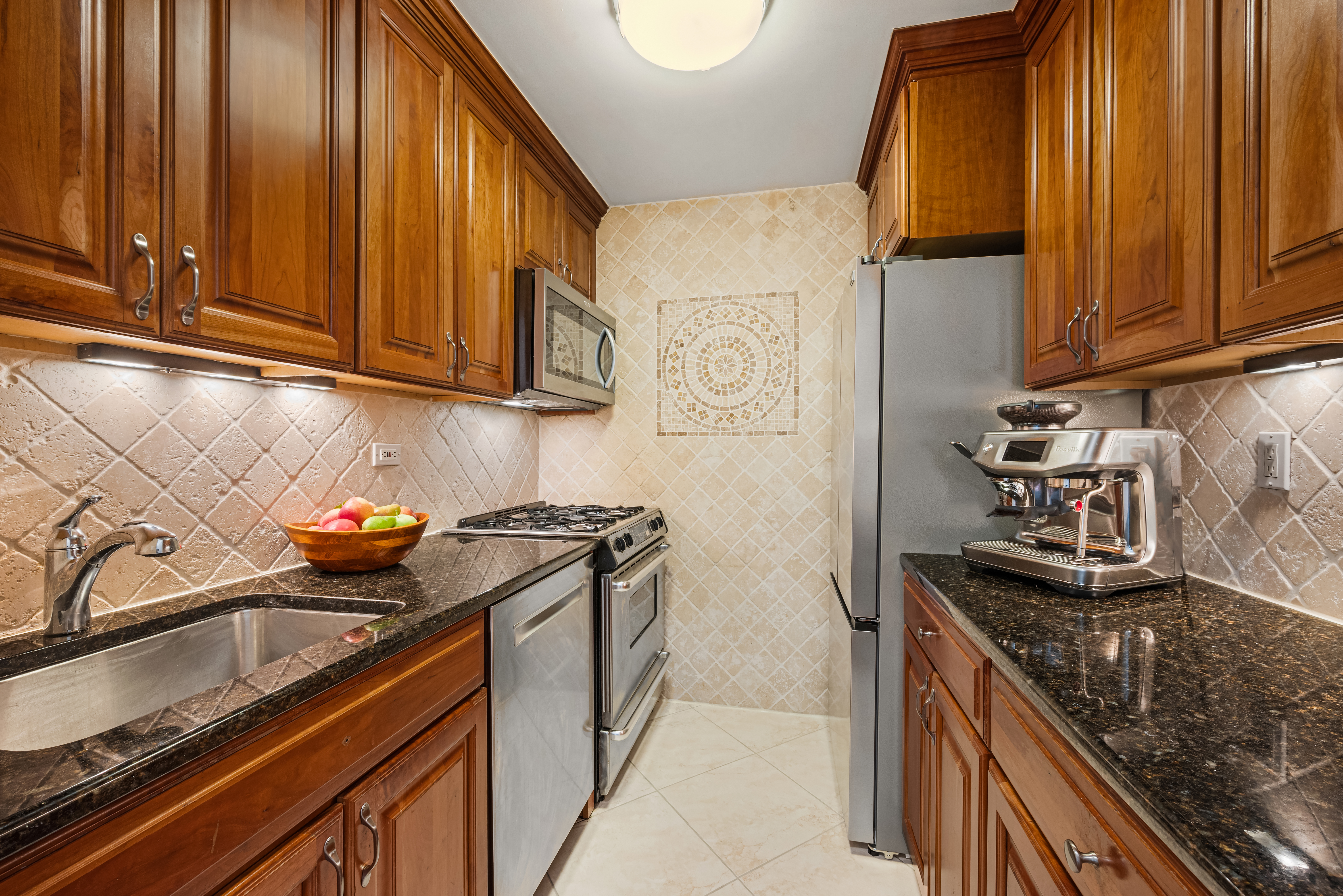 a kitchen with stainless steel appliances granite countertop a sink stove and refrigerator