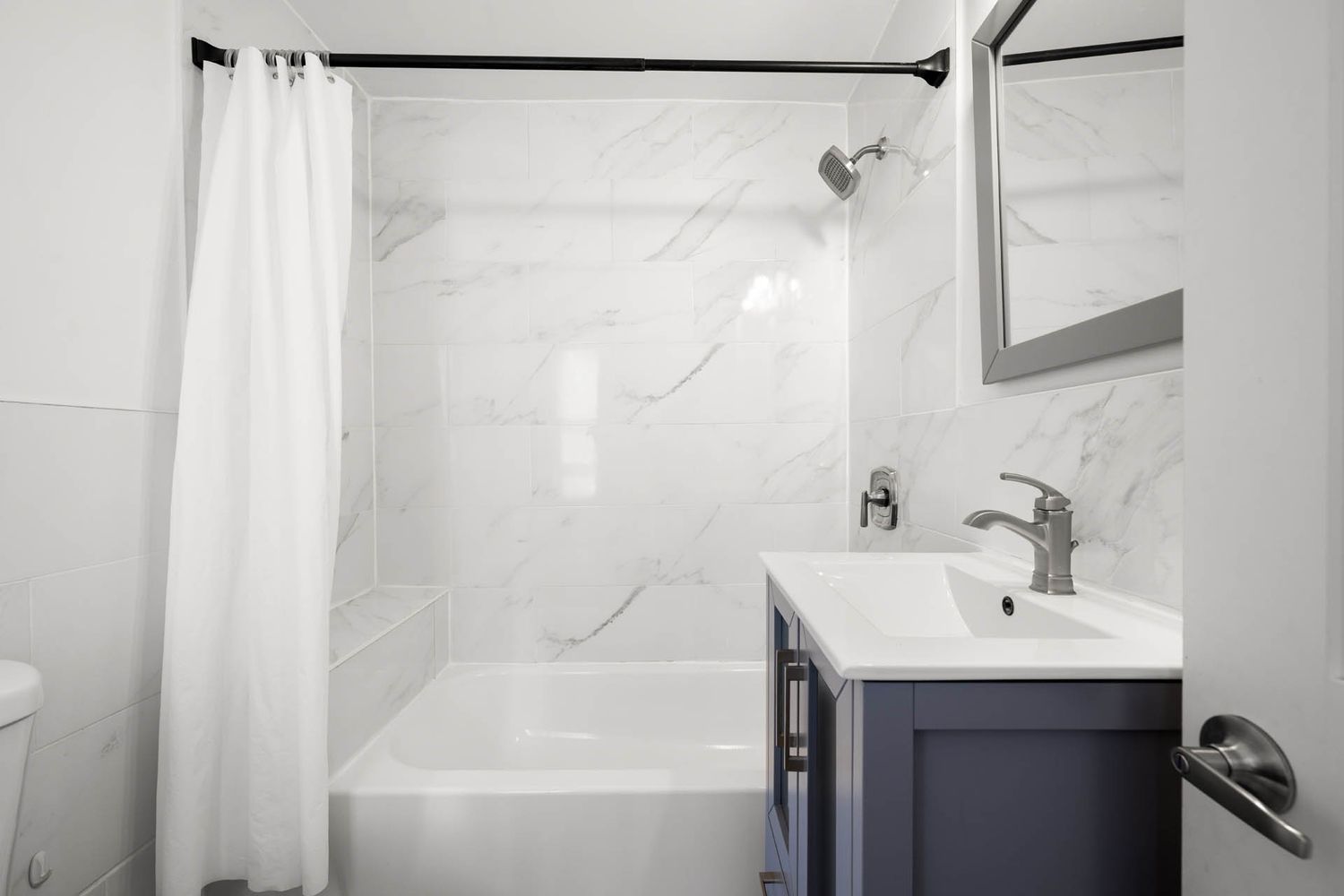 a bathroom with a shower and a sink