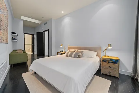 a bedroom with a bed and a couch