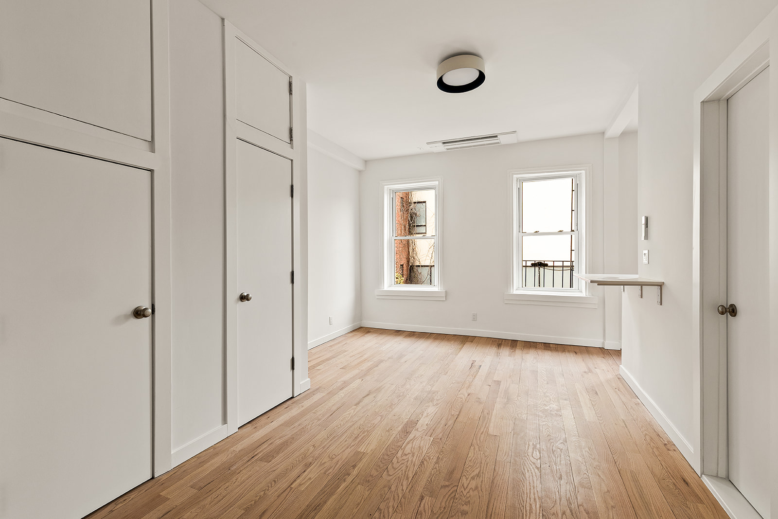 109 2nd Place Brooklyn, NY 11231 - Photo 13 of 26 a view of an empty room with wooden floor and a window